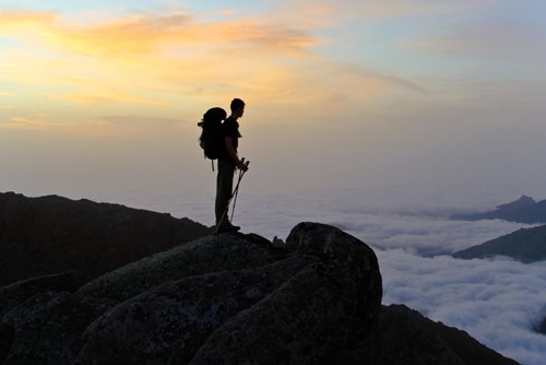 France_Corsica GR20 trekker silhouette with sunrise and cloud sea.jpg